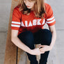 Alaska t-shirt in red and white football style tee.
